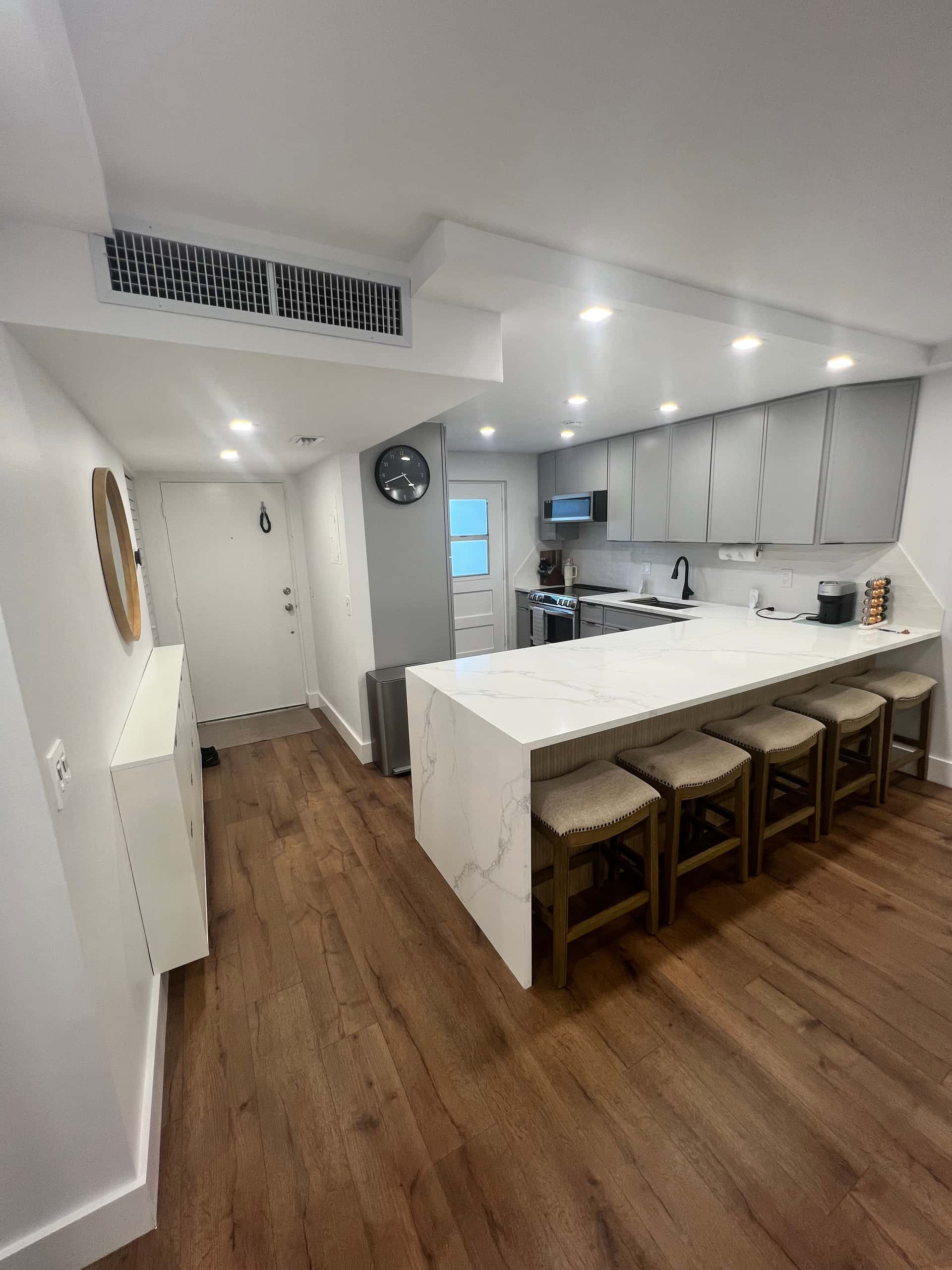 Compact Modern Kitchen with Gray Cabinets and Marble Countertops