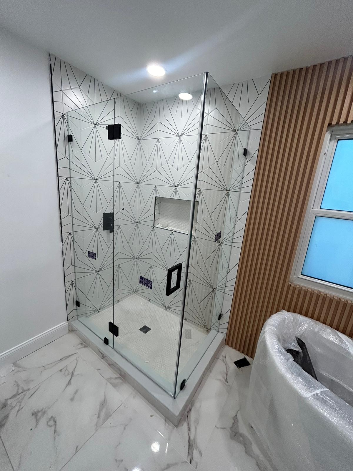 Modern Bathroom with Geometric Tile Design and Glass Shower Enclosure